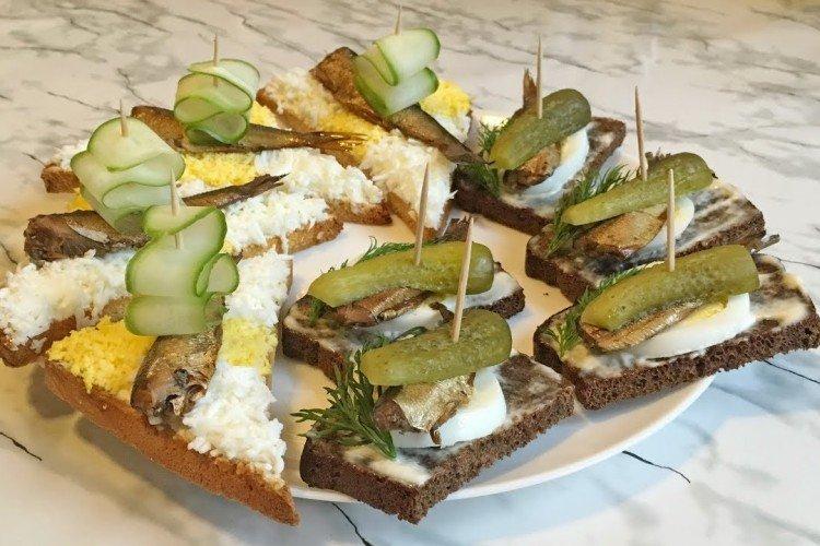 Kanapees mit Sprotten auf Spießen