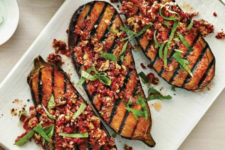 Mitades de berenjenas con tomates secos y nueces a la parrilla