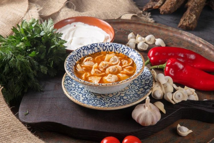 Chuchvara en caldo con tomates y pimiento dulce