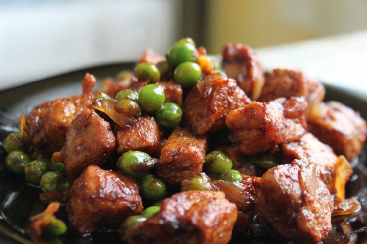 Pork with Vegetables and Green Peas in a Skillet