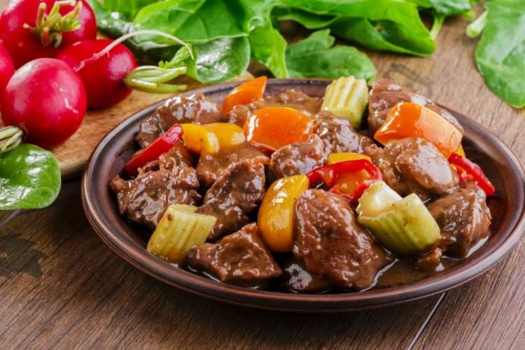 Pork with Vegetables and Celery in a Skillet
