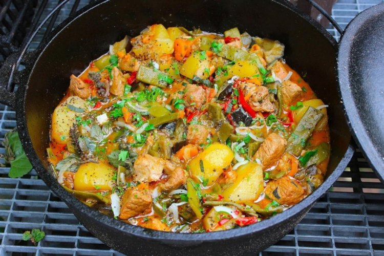 Patatas con carne y berenjenas en un caldero a la lumbre