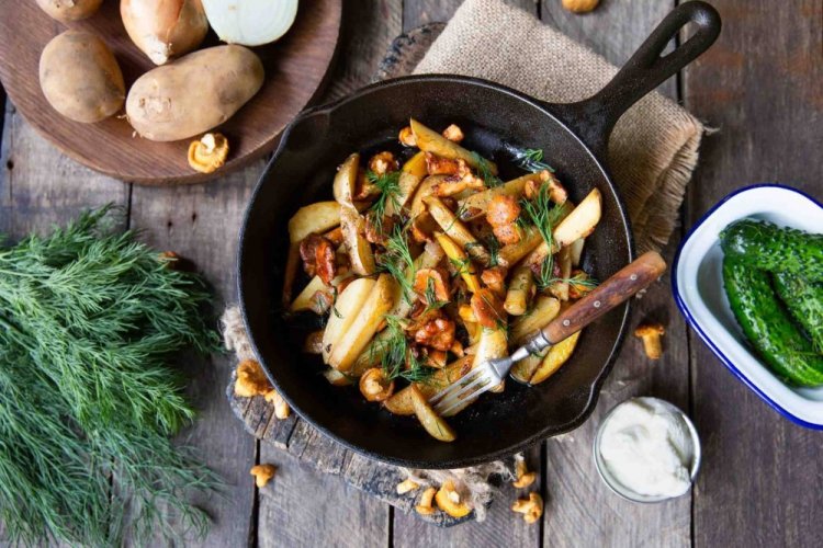 Fried Potatoes with Chanterelles in Wine in a Skillet