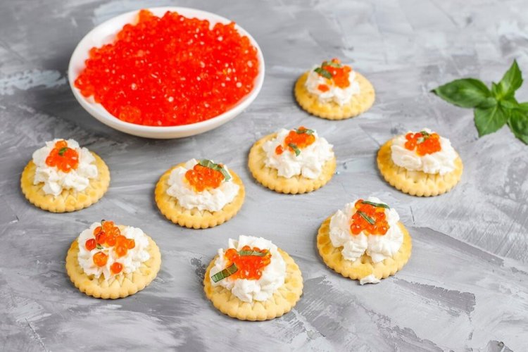 New Year's Canapés with Red Caviar on Crackers