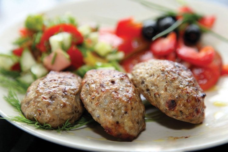 Chicken and Beef Cutlets on a Baking Sheet in the Oven