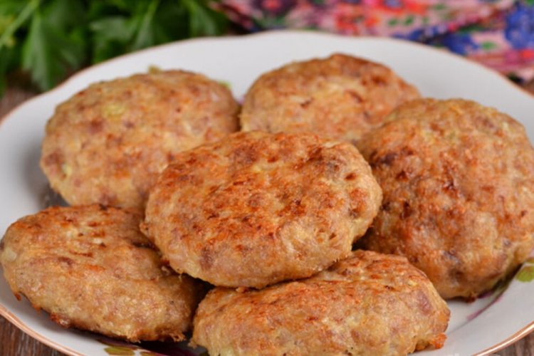 Breaded Cutlets on a Baking Sheet in the Oven
