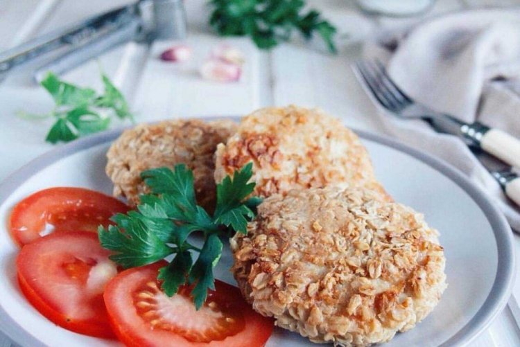 Healthy Cutlets with Rolled Oats on a Baking Sheet in the Oven