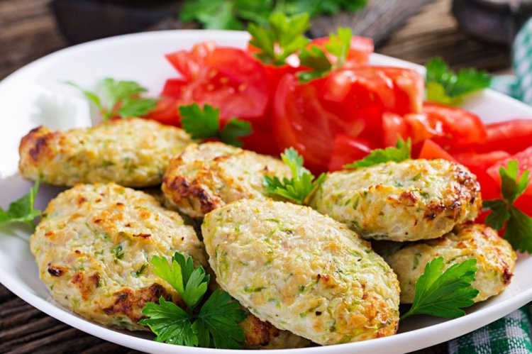 Turkey and Zucchini Cutlets on a Baking Sheet in the Oven