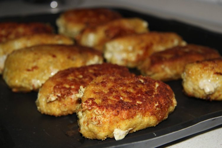 Cottage Cheese Cutlets on a Baking Sheet in the Oven