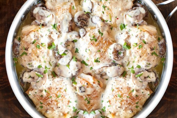 Chicken Thighs with Mushrooms in a Skillet