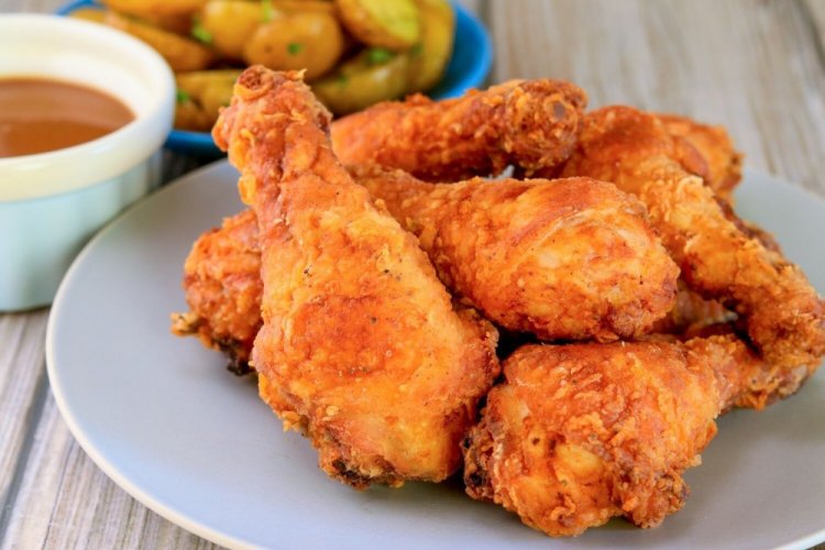 Muslos de pollo rebozados con cebolla en sartén