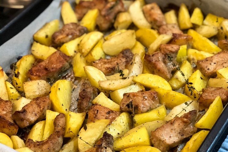 Meat with Potatoes and Mustard on a Baking Sheet in the Oven