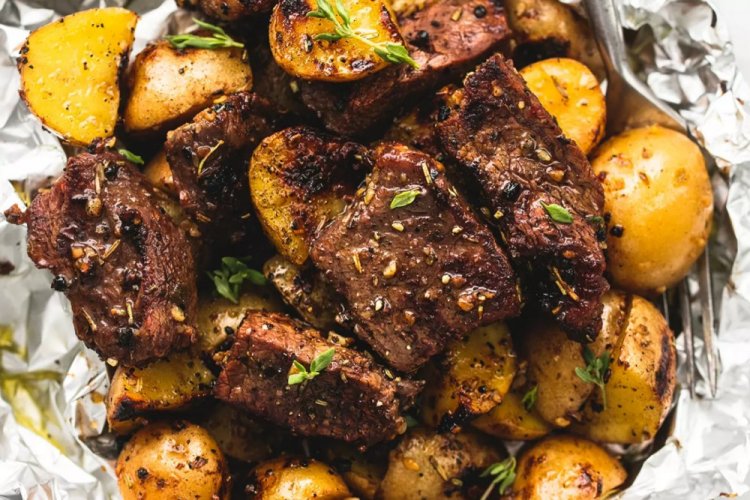 Meat with Potatoes and Honey on a Baking Sheet in the Oven