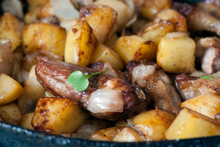 Fried Potatoes with Meat and Garlic in a Skillet