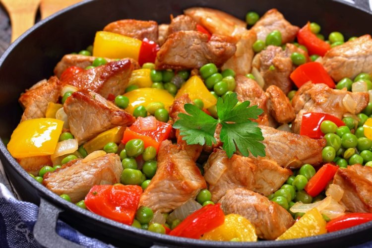 Fried Potatoes with Meat and Vegetables in a Skillet