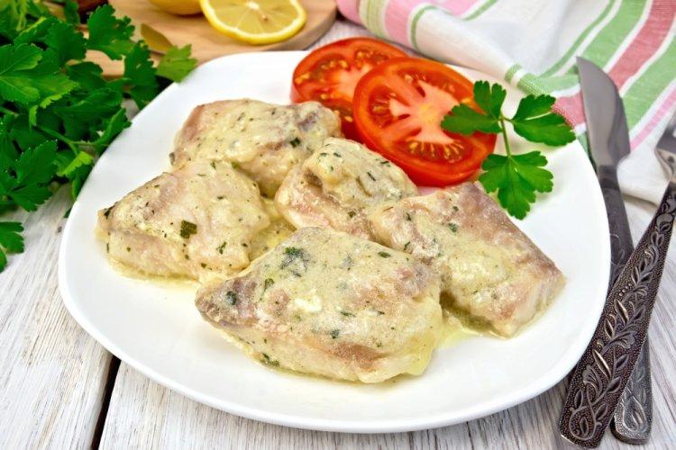 Pollock with Onion and Sour Cream in a Skillet