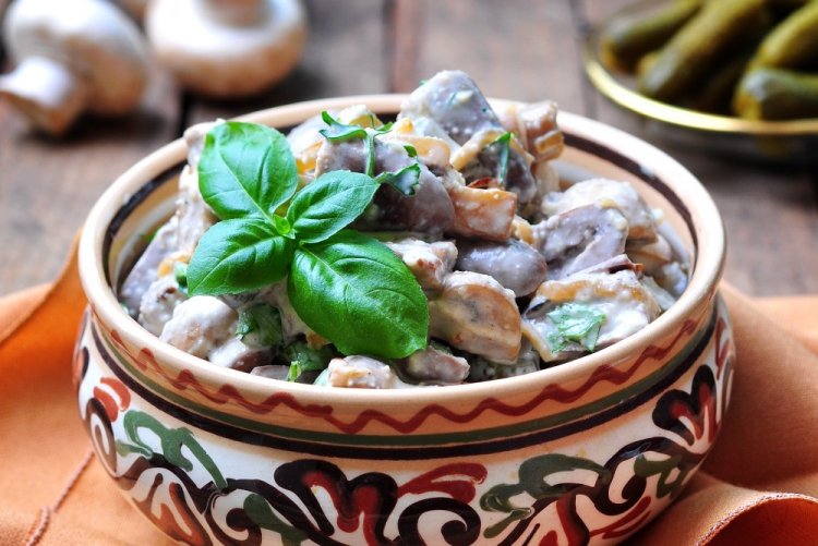 Chicken Hearts with Mushrooms in Sour Cream in a Skillet