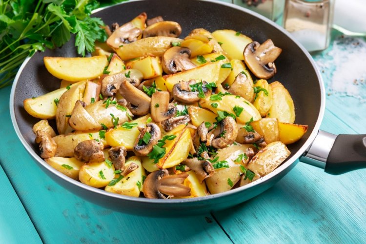 Fried Potatoes with Onions and Mushrooms in a Pan