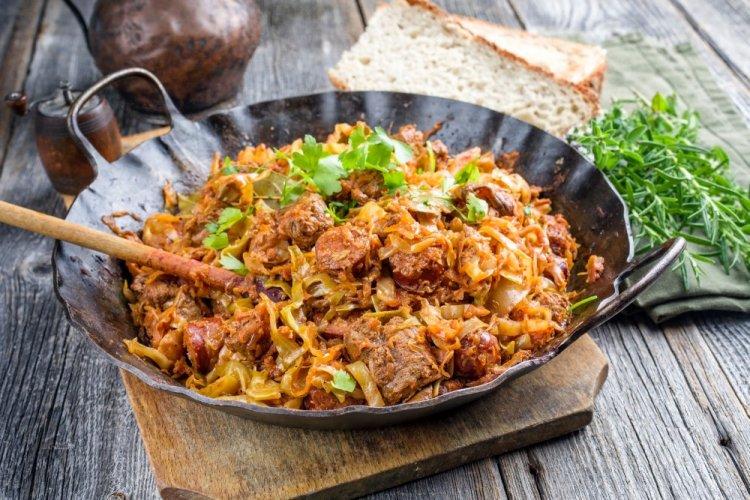 Col estofada con cerdo y salchichas en olla afgana