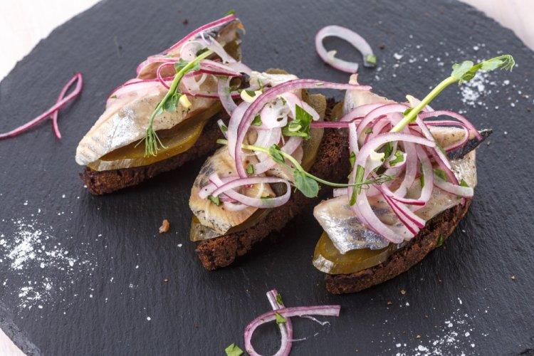 Bruschetta with Herring, Pickled Cucumbers, and Red Onion