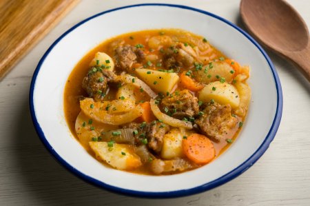10 Hearty Potato and Meat Recipes in a Cauldron over a Campfire